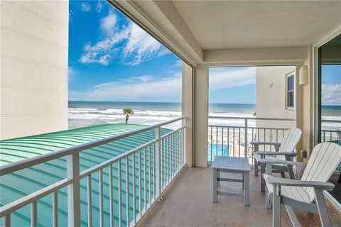 a balcony with table and chairs