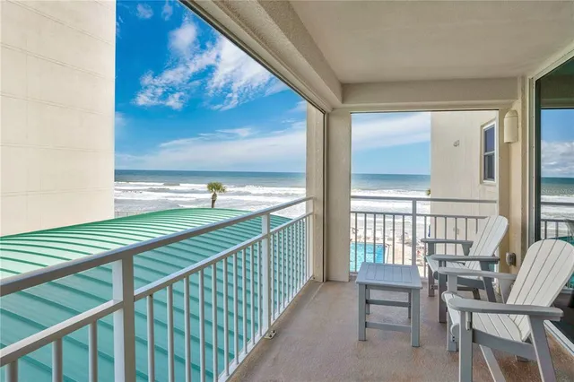 a balcony with table and chairs
