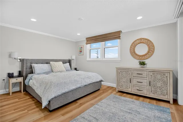 a bedroom with a large bed and a dresser