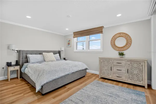 a bedroom with a large bed and a dresser