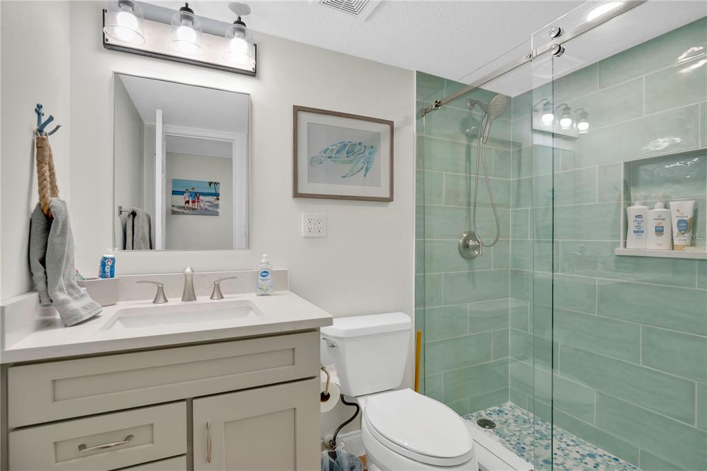 4505 South Atlantic Avenue, Unit 305 Ponce Inlet, FL 32127 - Photo 23 of 34 a bathroom with a sink toilet and shower