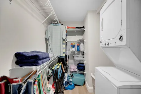 a view of walk in closet with clothes and shoes