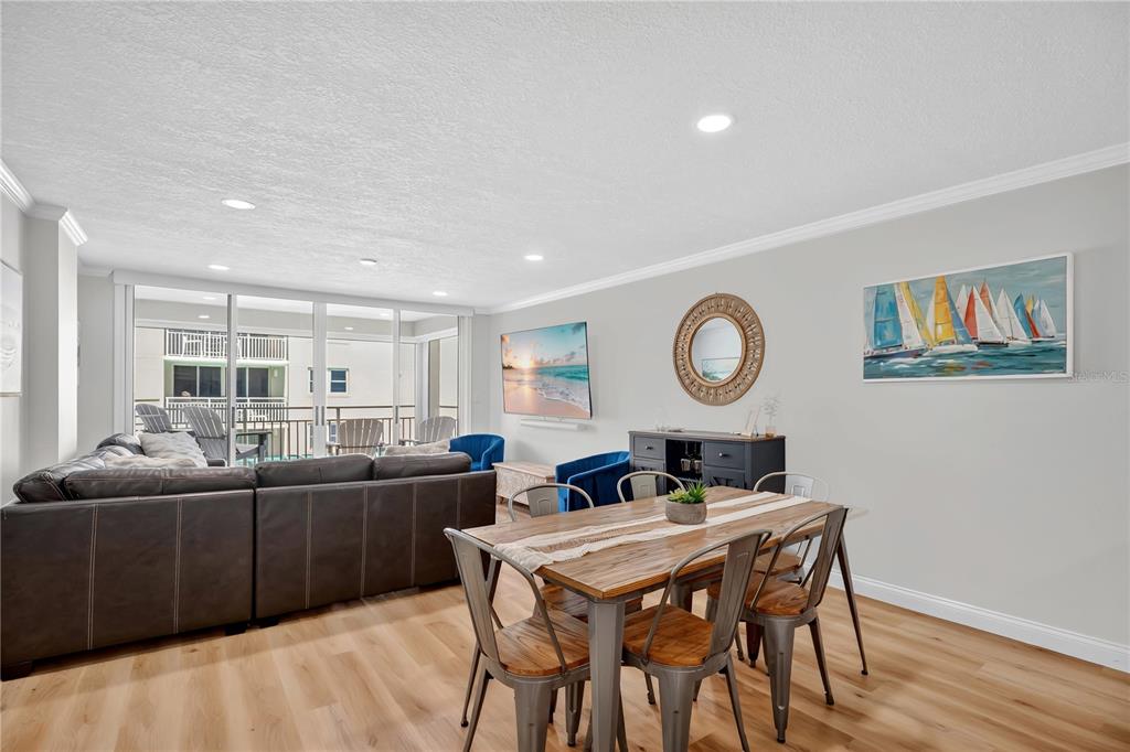 4505 South Atlantic Avenue, Unit 305 Ponce Inlet, FL 32127 - Photo 4 of 34 a view of a dining room with furniture and wooden floor