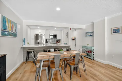 a dining room with furniture and wooden floor