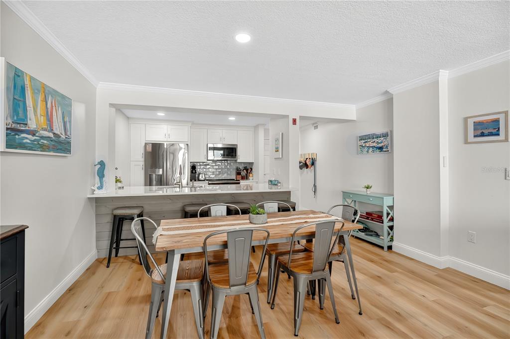 4505 South Atlantic Avenue, Unit 305 Ponce Inlet, FL 32127 - Photo 10 of 34 a dining room with furniture and wooden floor