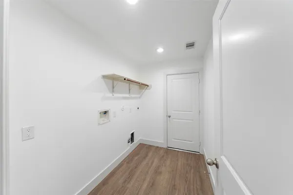 a view of hallway with wooden floor