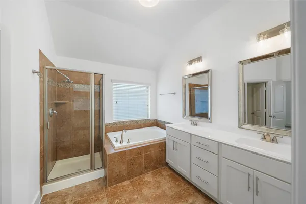 a bathroom with a double vanity sink mirror and shower