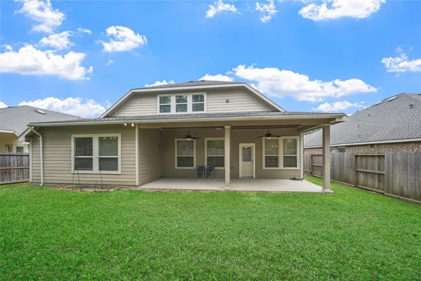 a front view of a house with a garden and yard