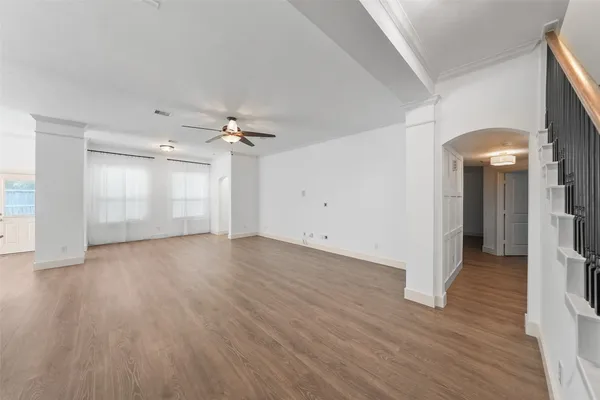 wooden floor in an empty room with a window