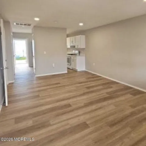 a view of a kitchen with a sink and a refrigerator