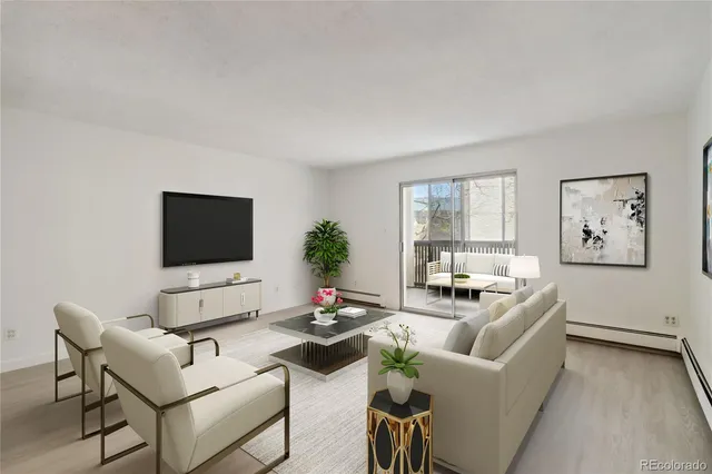 a living room with furniture a flat screen tv and a large window