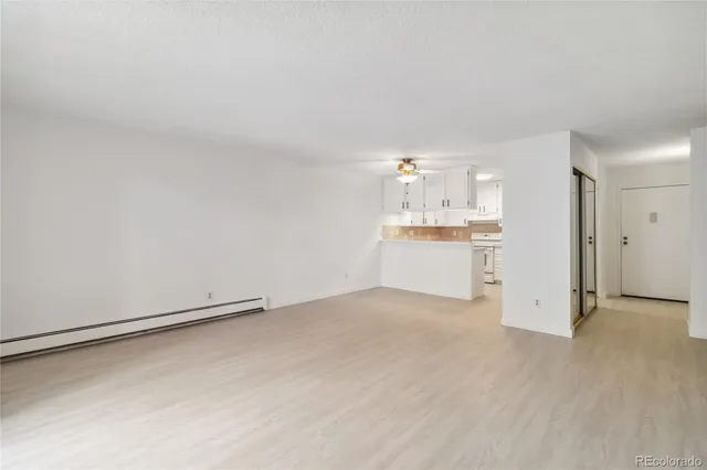 a view of a kitchen with a sink and a refrigerator