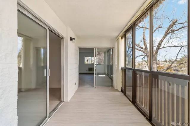 a view of a hallway with wooden shelves