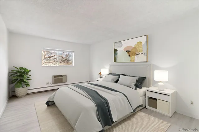 a bedroom with a bed and a painting on the wall