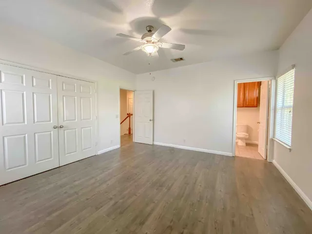 a bathroom with a sink a toilet a mirror and shower