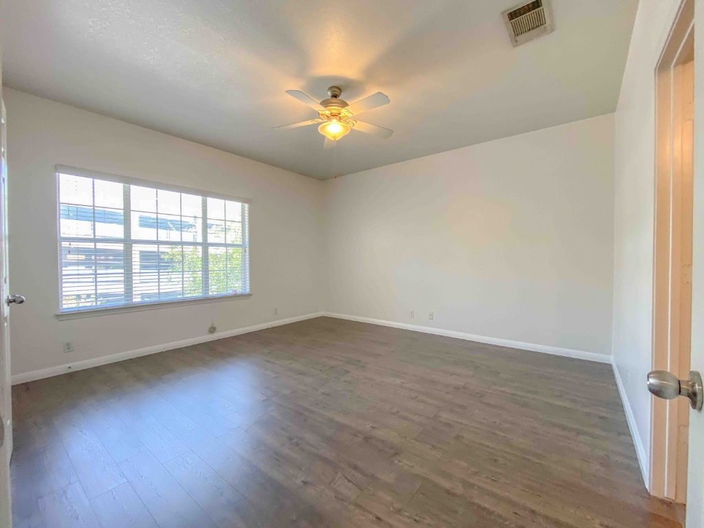 609 West 37th Street Austin, TX 78705 - Photo 26 of 38 an empty room with wooden floor fan and windows
