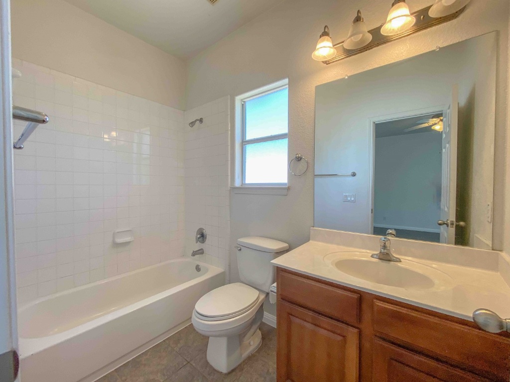 609 West 37th Street Austin, TX 78705 - Photo 32 of 38 a bathroom with a sink a toilet a mirror and shower