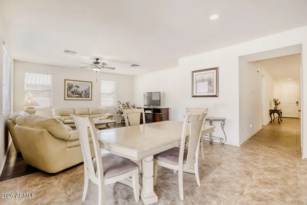 a bedroom with a bed and a lamp on a dresser