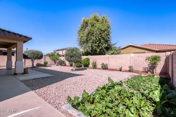 a living room with furniture a flat screen tv and a refrigerator