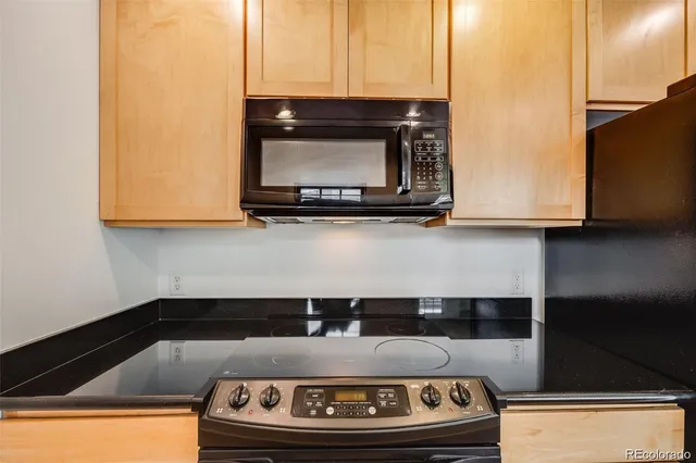 a kitchen with granite countertop a sink and a stove