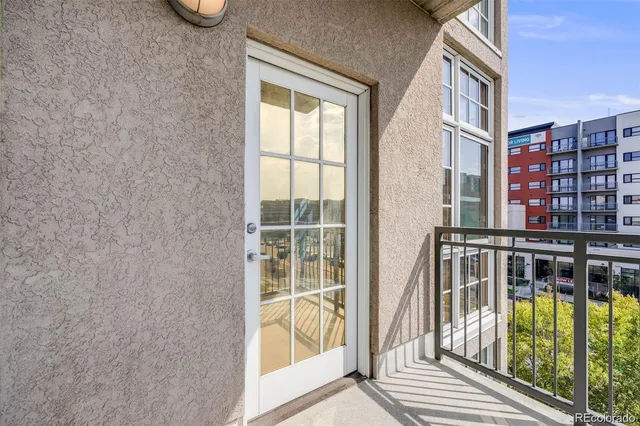 a view of a dining room with furniture and floor to ceiling window