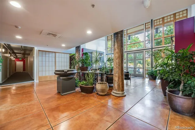 a living room with fireplace furniture and a large window