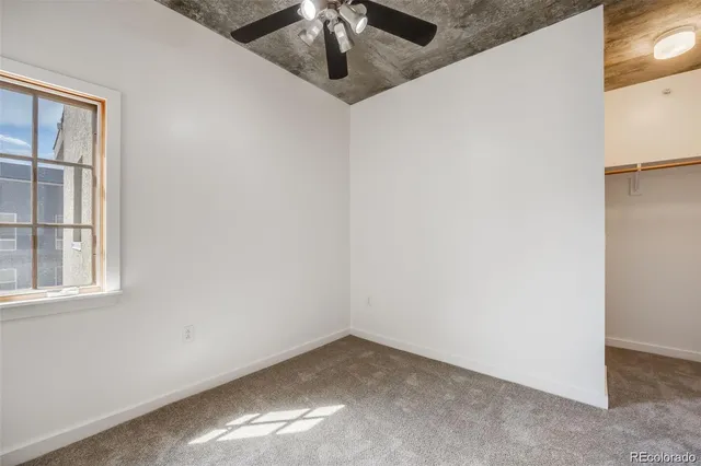 a view of walk in closet with empty racks