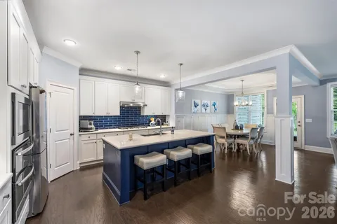 a large kitchen with a table and chairs