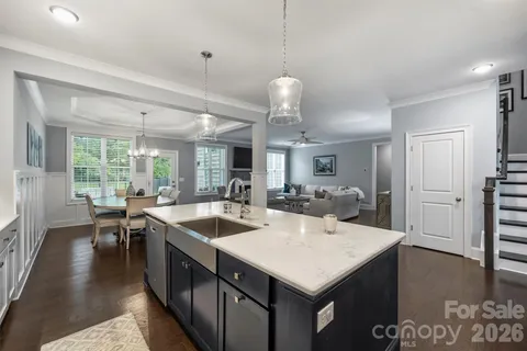 a kitchen with sink stove and refrigerator