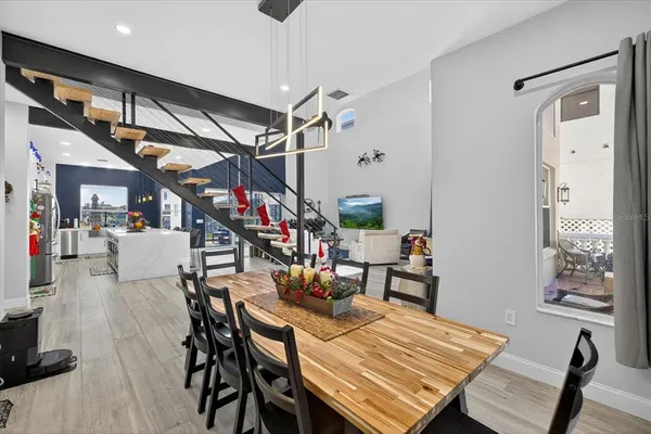 a large white kitchen with stainless steel appliances granite countertop a stove and a wooden floors