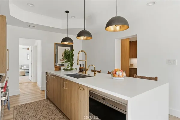 a kitchen with a sink and a chandelier