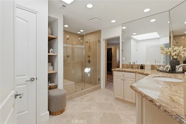 a large bathroom with a granite countertop sink mirror and shower