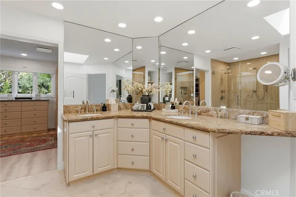 a large bathroom with a large mirror vanity and sink