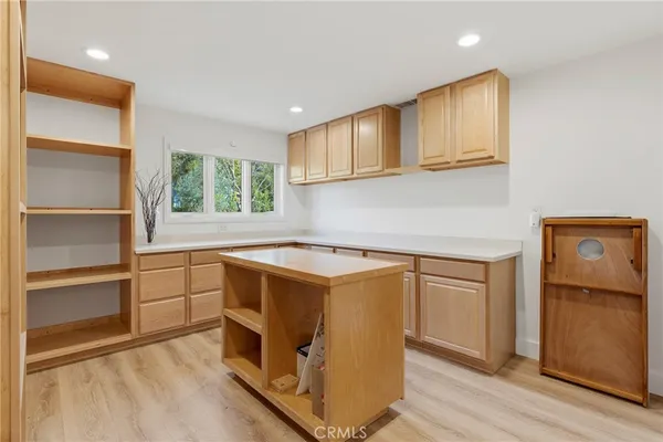 a kitchen with wooden cabinets and a refrigerator