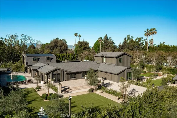 an aerial view of a house with swimming pool and garden view