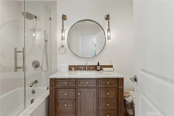 a bathroom with a sink a vanity and a mirror