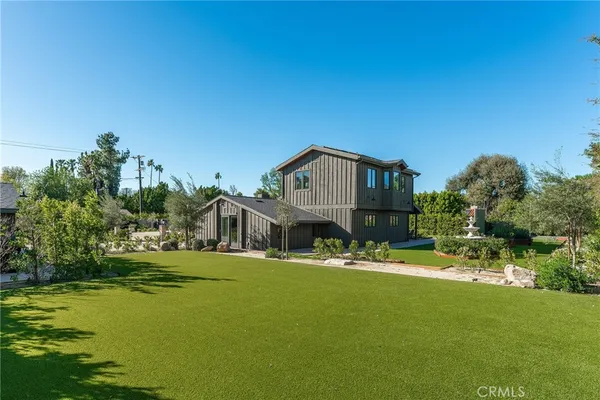 a view of house with outdoor space and swimming pool