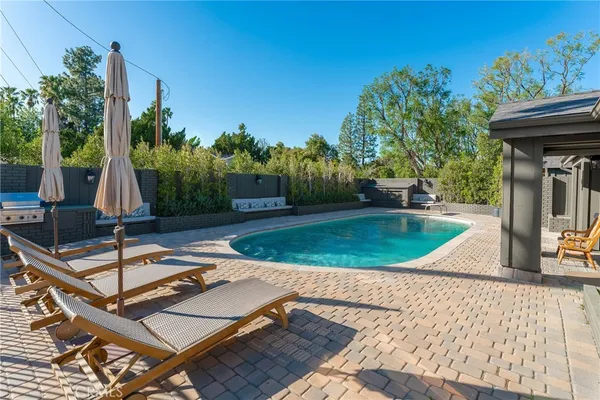 a view of a backyard with a sitting area