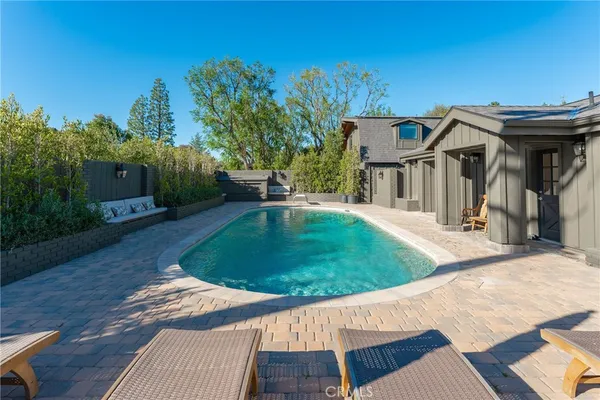 a view of a house with a yard and furniture