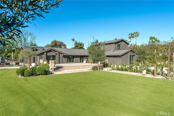 a front view of a house with a garden