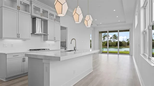 a kitchen with a sink and a stove top oven