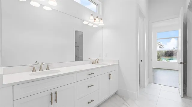 a bathroom with a double vanity sink and a mirror