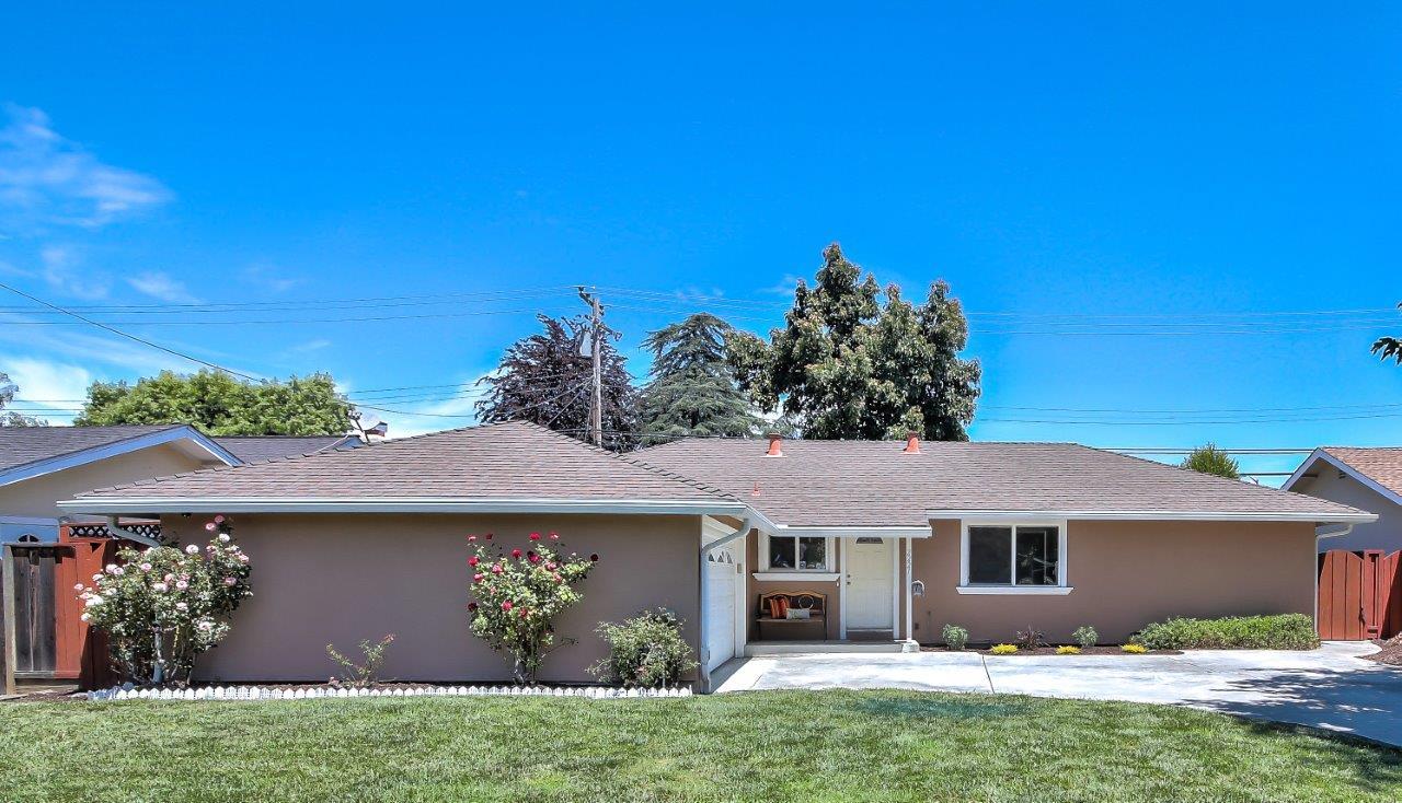 a front view of house with yard and green space