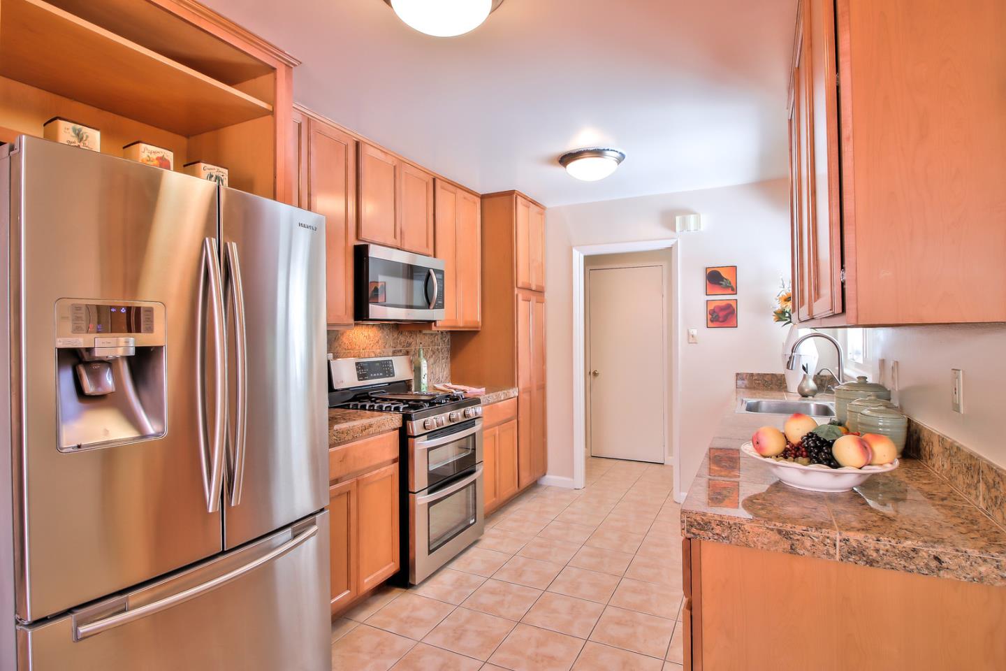 2221 Sutter Avenue Santa Clara, CA 95050 - Photo 13 of 29 a kitchen with stainless steel appliances granite countertop a refrigerator stove and sink