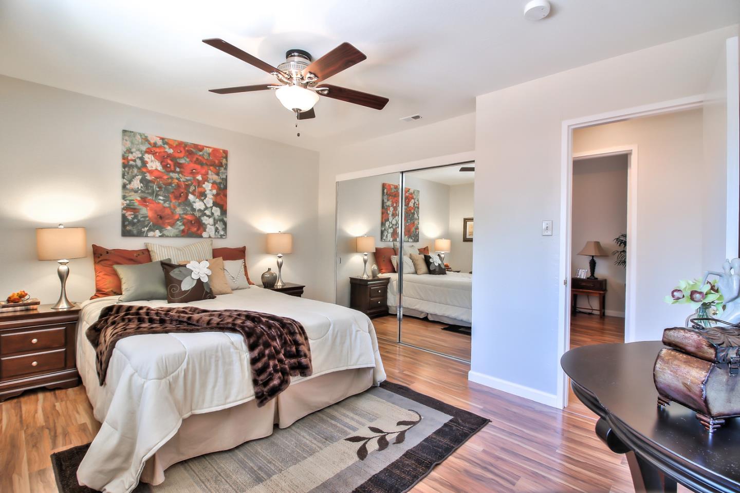 2221 Sutter Avenue Santa Clara, CA 95050 - Photo 14 of 29 a bedroom with a large bed and a chandelier