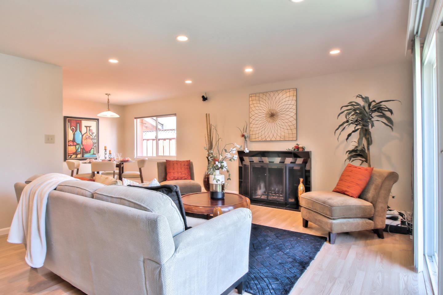 2221 Sutter Avenue Santa Clara, CA 95050 - Photo 6 of 29 a living room with furniture a fireplace and a potted plant