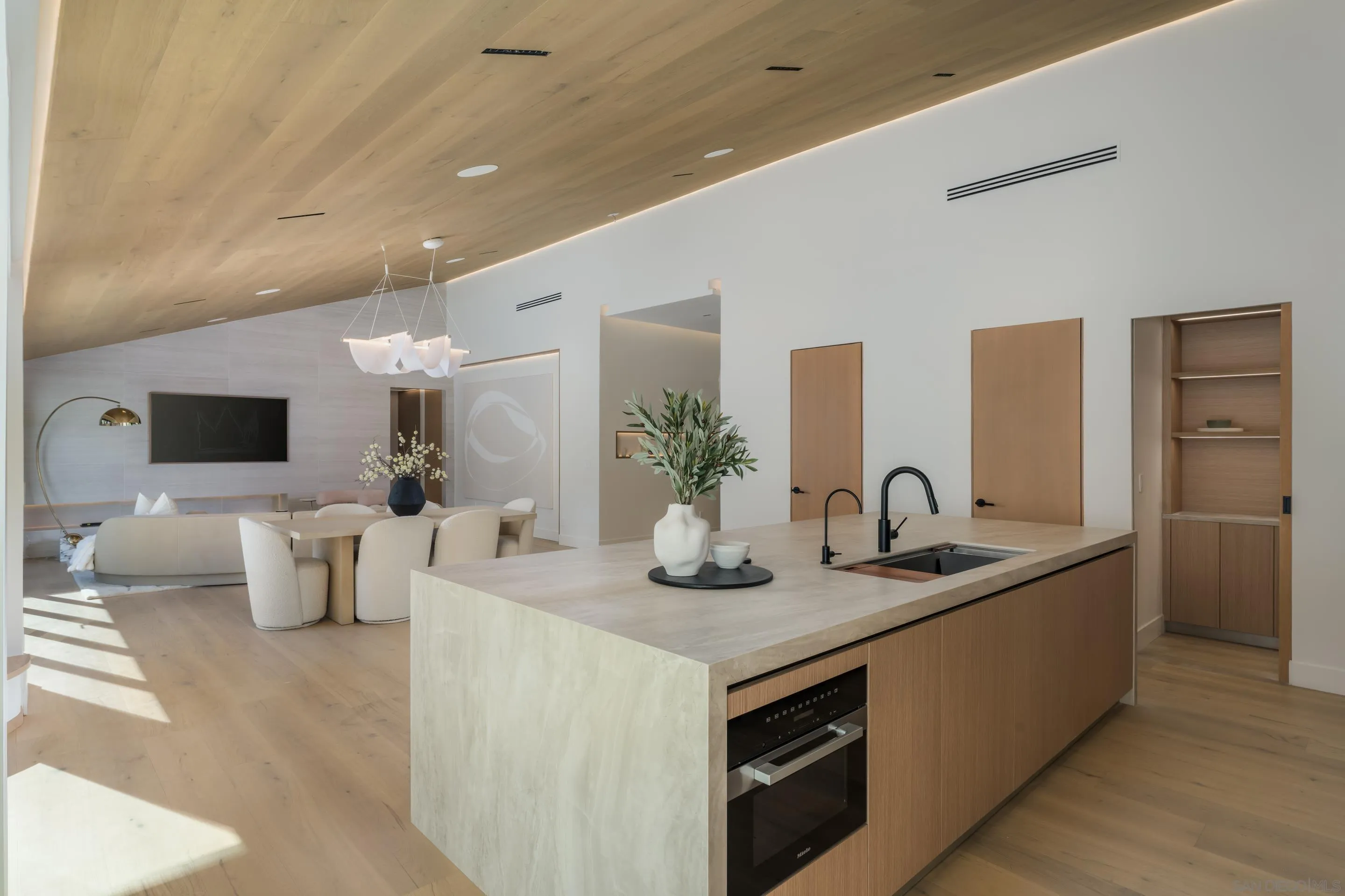 5826 Soledad Mountain Road La Jolla, CA 92037 - Photo 11 of 52 a kitchen with a sink and living room view
