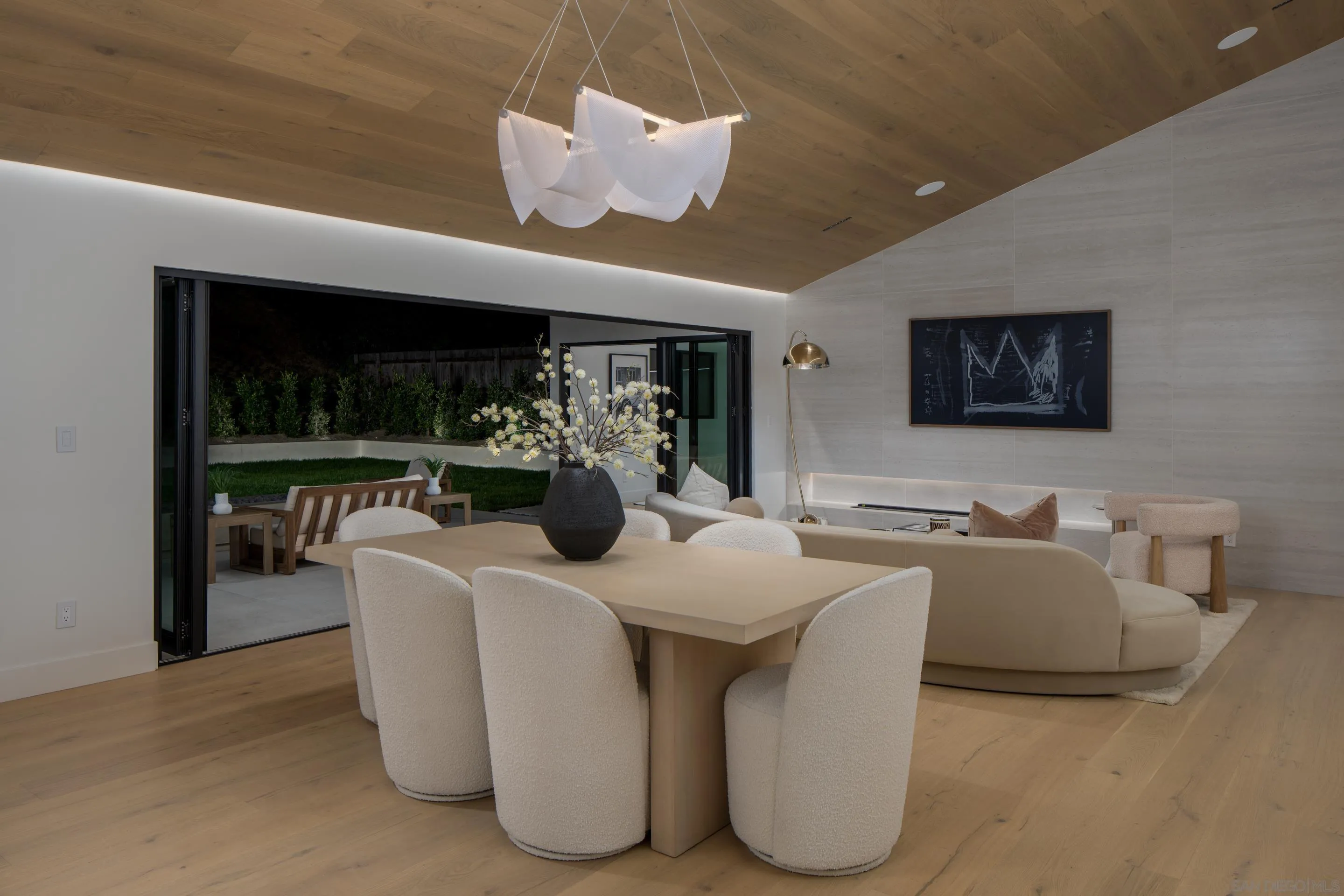 5826 Soledad Mountain Road La Jolla, CA 92037 - Photo 13 of 52 a view of a dining room with furniture and chandelier