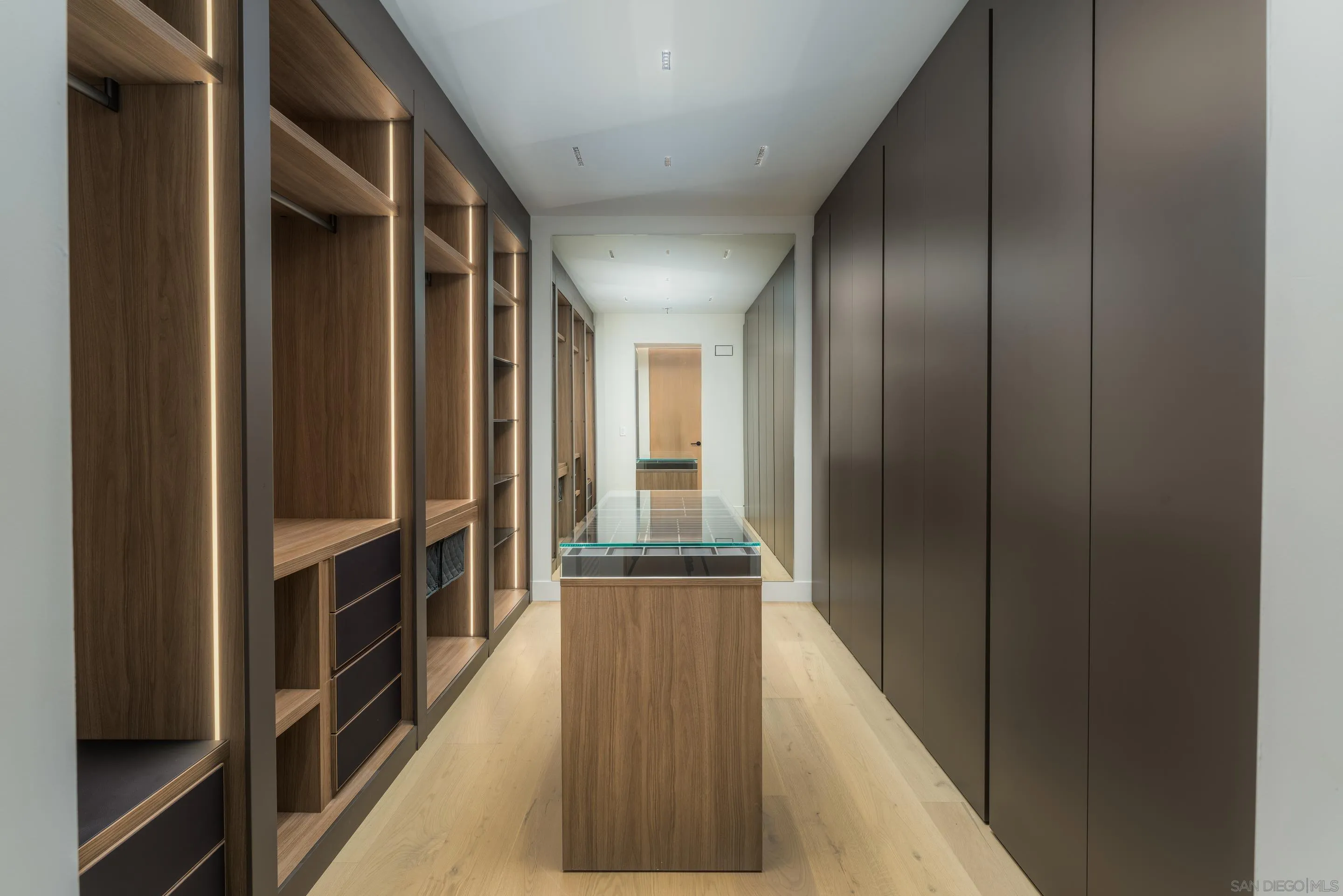 5826 Soledad Mountain Road La Jolla, CA 92037 - Photo 18 of 52 a view of a hallway with wooden floor and staircase