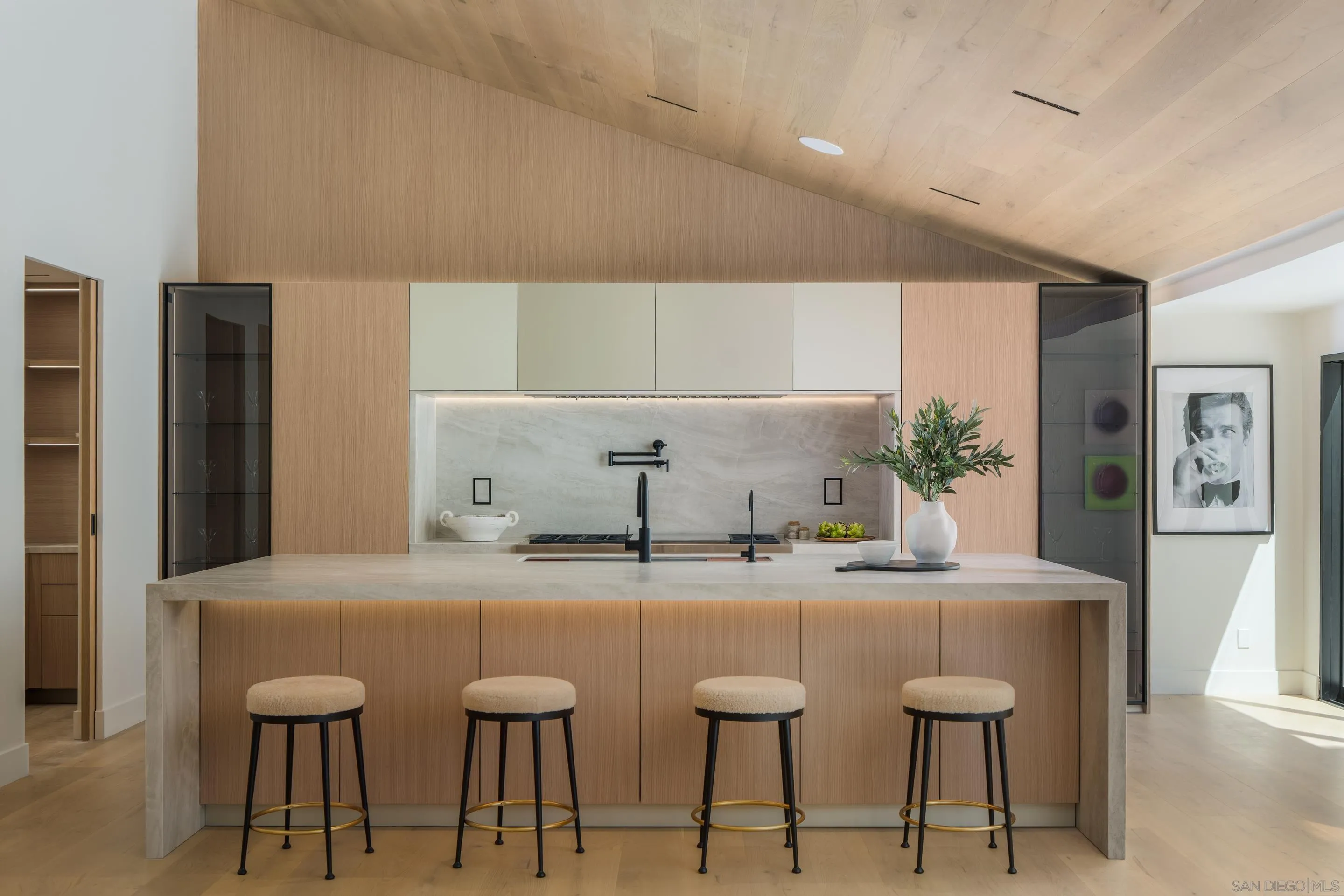 5826 Soledad Mountain Road La Jolla, CA 92037 - Photo 8 of 52 a kitchen with stainless steel appliances kitchen island granite countertop a table and chairs